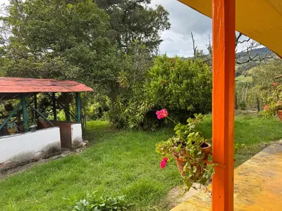 a garden with a gazebo and some flowers at Casa de campo a 5 minutos from Sonsón in Sonsón