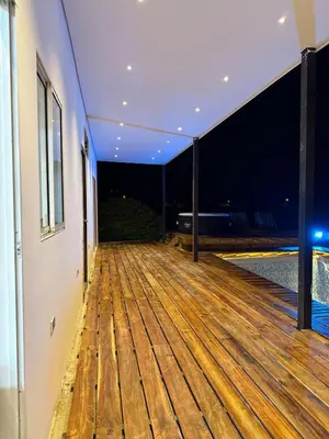 an empty deck in a house at night at Villa de lujo con piscina, jacuzzi y vista maravillosa in El Peñol