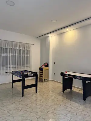 a room with two ping pong tables in it at Villa de lujo con piscina, jacuzzi y vista maravillosa in El Peñol