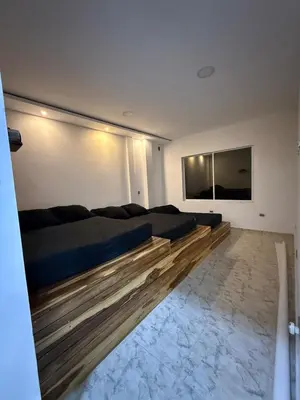 a bedroom with a large bed and a flat screen tv at Villa de lujo con piscina, jacuzzi y vista maravillosa in El Peñol