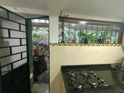 a kitchen with a stove and some plants at Aparta Hotel Campestre para 5H Poblado San Lucas apt 112 in Medellín