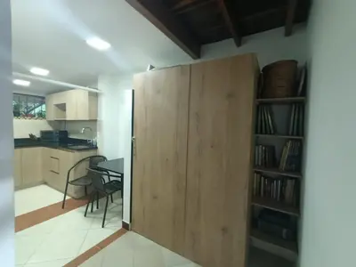 a large wooden door in a kitchen with a table at Aparta Hotel Campestre para 5H Poblado San Lucas apt 112 in Medellín
