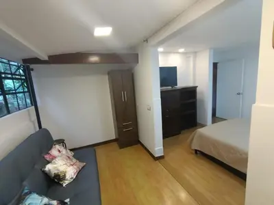 a living room with a couch and a bed at Aparta Hotel Campestre para 5H Poblado San Lucas apt 112 in Medellín