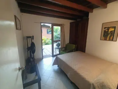 a bedroom with a bed and a door to a patio at Aparta Hotel Campestre para 5H Poblado San Lucas apt 112 in Medellín