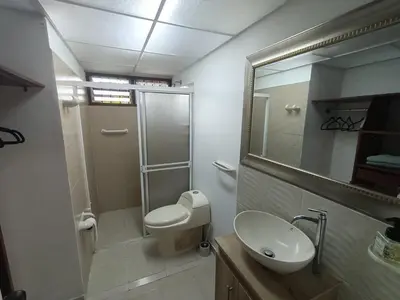 a bathroom with a toilet and a sink and a mirror at Aparta Hotel Campestre para 5H Poblado San Lucas apt 112 in Medellín