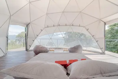 a bedroom with a bed in a tent at Deluxe Glamping Domo in Copacabana
