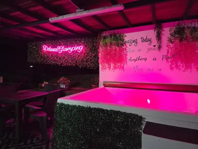 a ping pong table in a restaurant with pink lights at Deluxe Glamping Domo in Copacabana