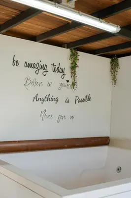 a white wall with a sign on it at Deluxe Glamping Domo in Copacabana
