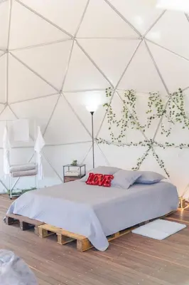 a bedroom with a bed in a tent at Deluxe Glamping Domo in Copacabana