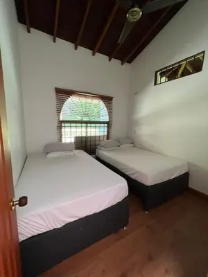 two beds in a room with a window at Finca san julian in San Jerónimo