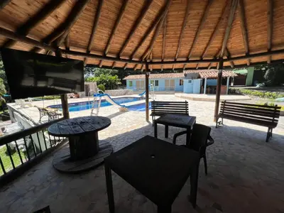 a patio with a table and chairs and a pool at Finca san julian in San Jerónimo