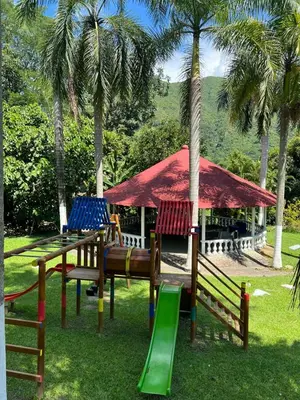 a park with chairs and a playground with palm trees at Finca san julian in San Jerónimo