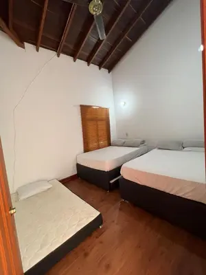 a room with two beds and a window at Finca san julian in San Jerónimo