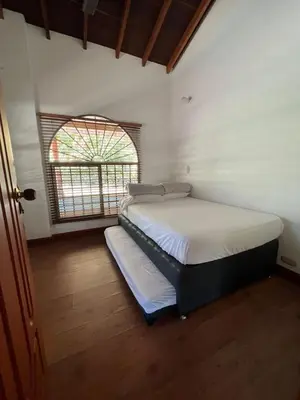 a bedroom with two beds in a room with a window at Finca san julian in San Jerónimo