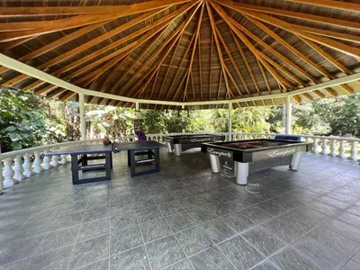 two ping pong tables on a patio with a roof at Finca san julian in San Jerónimo