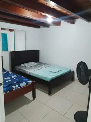 a bedroom with two beds in a room at Casa Santy in Santa Fe de Antioquia