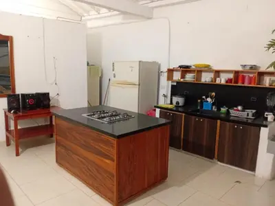 a kitchen with a stove and a refrigerator at Casa Santy in Santa Fe de Antioquia
