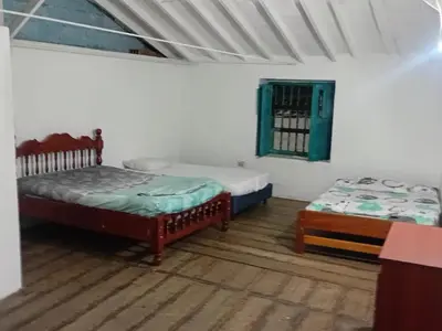 a room with two beds and a window in it at Casa Santy in Santa Fe de Antioquia