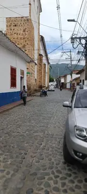 a street with a car parked on the side of a building at Casa Santy in Santa Fe de Antioquia