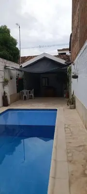 a blue swimming pool in front of a house at Casa Santy in Santa Fe de Antioquia