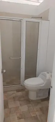 a bathroom with a toilet and a glass shower at Casa Santy in Santa Fe de Antioquia