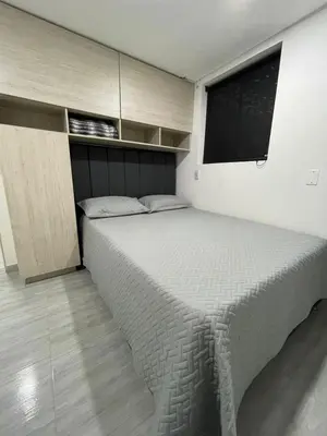a bedroom with a large bed with a window at Hotel boutique Olaya 54 in Medellín