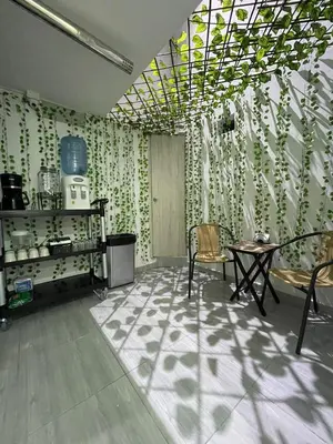a room with a table and chairs and a ceiling with plants at Hotel boutique Olaya 54 in Medellín