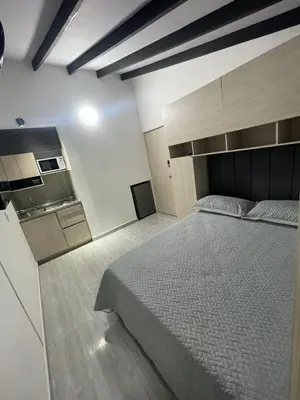 a bedroom with a large bed and a kitchen at Hotel boutique Olaya 54 in Medellín