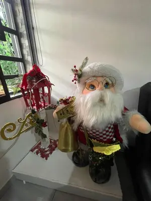 a santa claus figurine sitting on a table at Hotel boutique Olaya 54 in Medellín