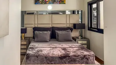 a bedroom with a large bed and two night stands at Urban Lofts Laureles 40 in Medellín