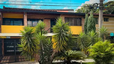 a building with palm trees in front of it at Urban Lofts Laureles 40 in Medellín