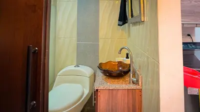 a small bathroom with a toilet and a sink at Urban Lofts Laureles 40 in Medellín