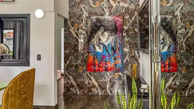 a room with three paintings on the wall at Urban Lofts Laureles 40 in Medellín