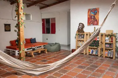 a room with a hammock in a living room at Hostal Abba in Medellín