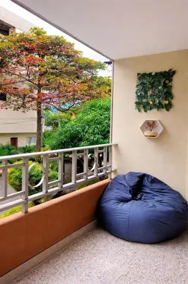 a blue bean bag sitting on a balcony with a window at Hostal Abba in Medellín