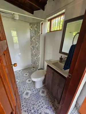 a bathroom with a toilet and a sink and a mirror at Don tranquilo in Alejandría