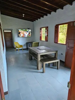 a dining room with a wooden table and a bench at Don tranquilo in Alejandría