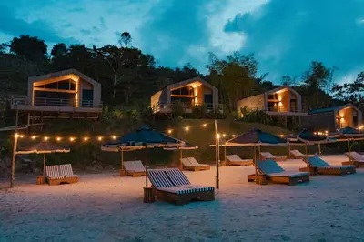 a group of chairs and umbrellas on a beach at Okai by Bernalo Hotels in Guatapé