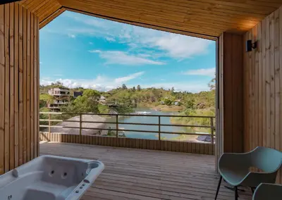 a bathroom with a tub and a large window at Okai by Bernalo Hotels in Guatapé