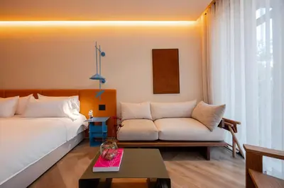a living room with a white couch and a table at The Cut Hotel in Medellín