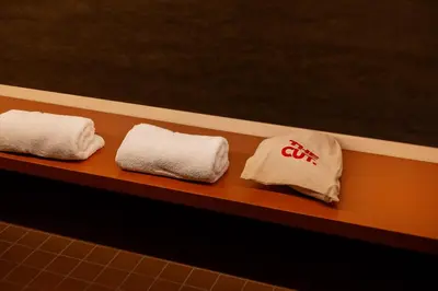 two towels sitting on a shelf in a bathroom at The Cut Hotel in Medellín