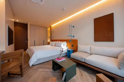 a hotel room with a bed and a couch at The Cut Hotel in Medellín