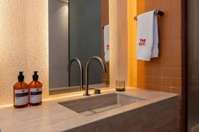 a bathroom with a sink and a mirror at The Cut Hotel in Medellín