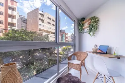 an apartment with a balcony with a desk and a laptop at Coffee Spring Studio Medellin in Medellín