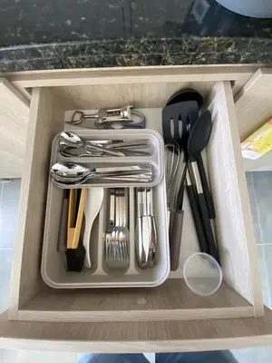 a drawer filled with utensils in a cabinet at calido y tranquilo apartamento in Sabaneta