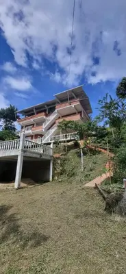 a building on top of a hill with a bridge at La Morada Del Gavilucho in San Carlos