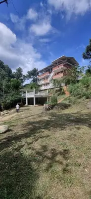 a building with a white bridge in a yard at La Morada Del Gavilucho in San Carlos