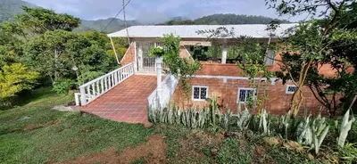 a brick house with a staircase in front of it at La Morada Del Gavilucho in San Carlos