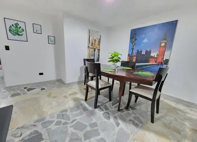 a dining room with a wooden table and chairs at Acogedor apto laureles estadio in Medellín