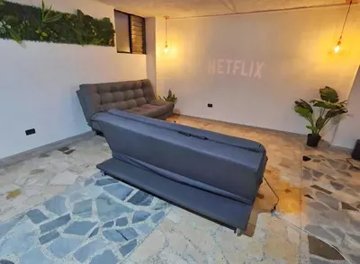 a couch sitting in a living room at Acogedor apto laureles estadio in Medellín